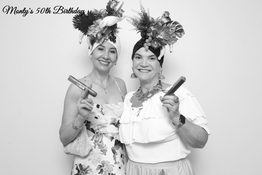 Two guests photographed in black and white at a birthday celebration, with a custom event overlay.
