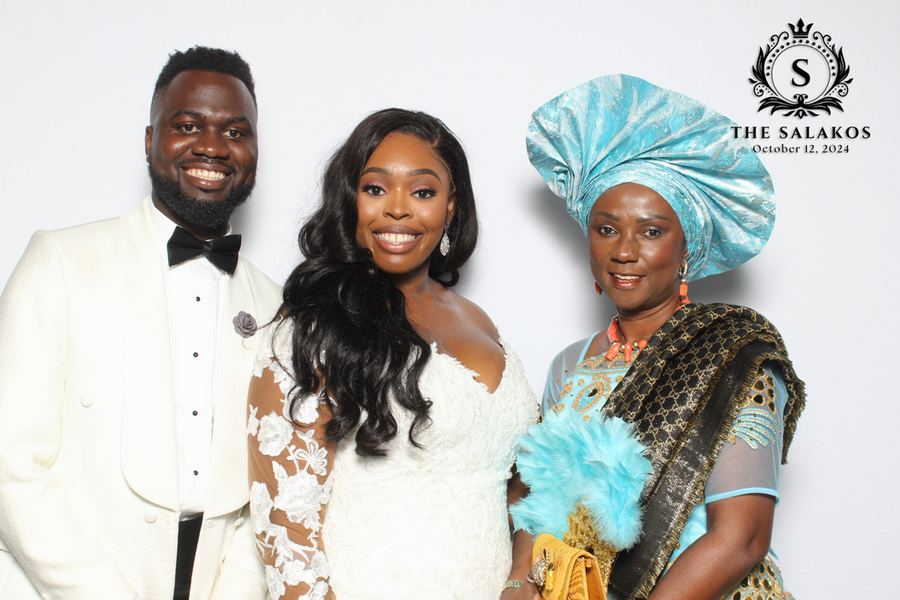 A wedding party photographed together, with the event&rsquo;s branded overlay along the edge.